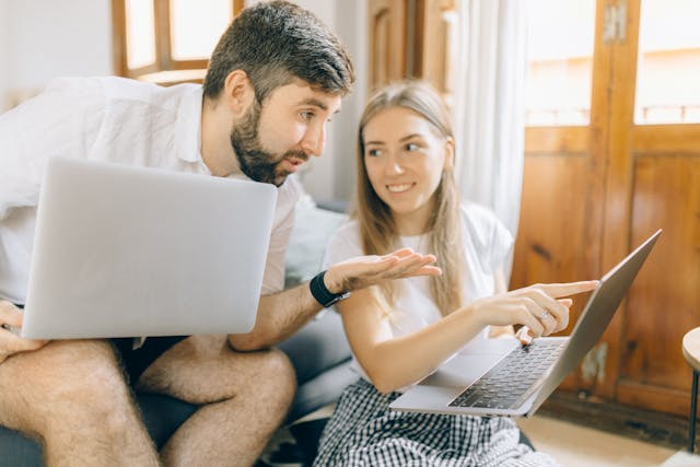 Business owner comparing website options on a laptop