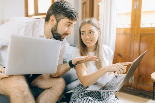 Business owner comparing website options on a laptop