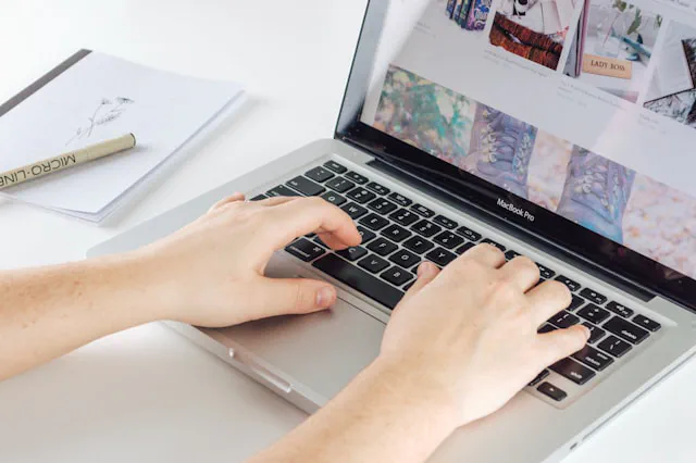 Business owner reviewing website content strategy on a laptop with notes