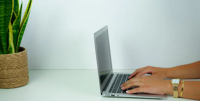Small business owner reviewing a professionally managed website on a laptop