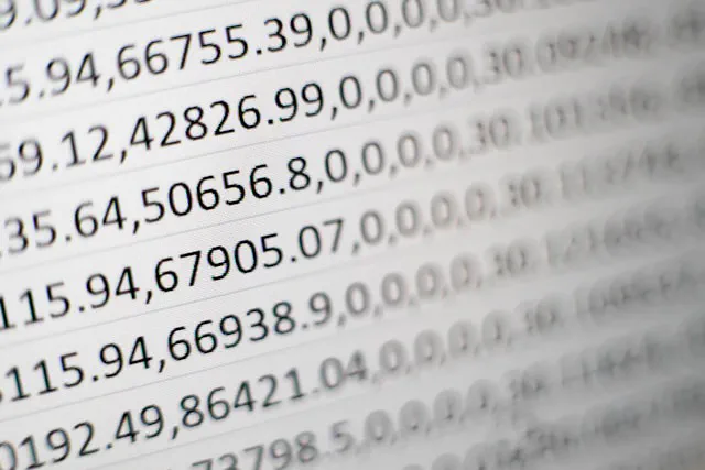 A complex business spreadsheet open on a laptop with multiple linked tabs