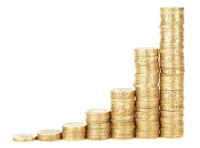 Stacks of gold coins arranged in ascending order, symbolising financial growth.