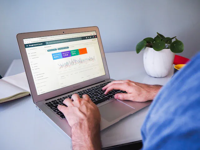 Small business owner reviewing website traffic and customer enquiries on a laptop